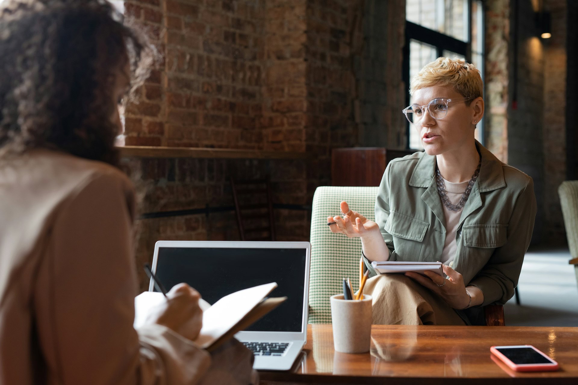 Two individuals are in a business meeting at a café.