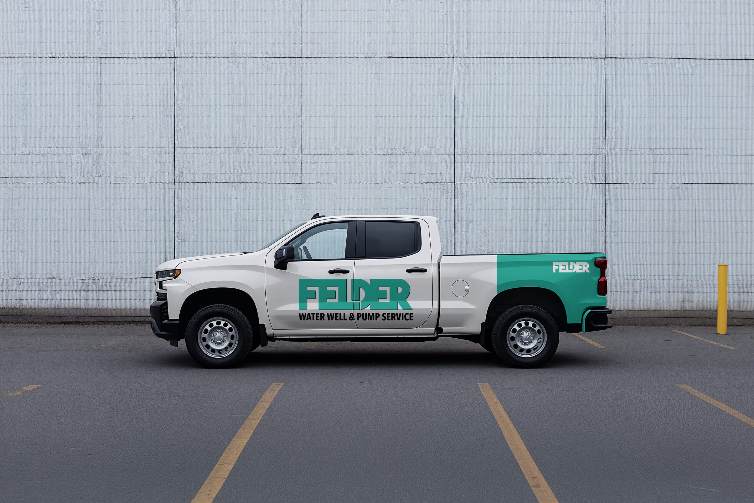 A white and green pickup truck with "Felder Water Well & Pump Service" branding is parked in a lot next to a painted yellow pole, with a light gray brick wall in the background. - Market Design Team: Define. Structure. Expand.