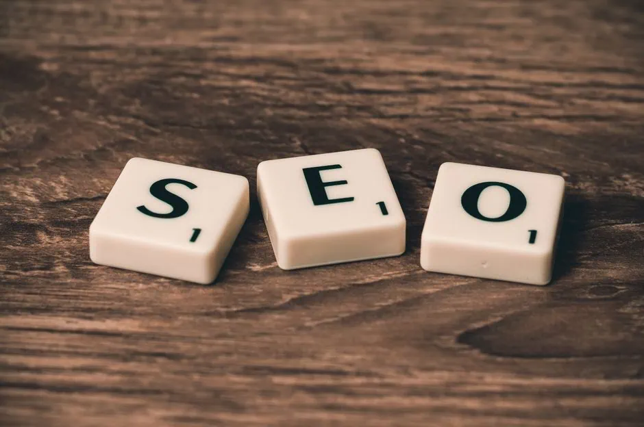 three white scrabble tiles with the black letters “s,” “e,” and “o” are placed on a brown wooden surface. the tiles represent the acronym seo, which stands for search engine optimization—a crucial tool for local businesses in brazosport to enhance their online presence through professional seo services. market design team: define. structure. expand.