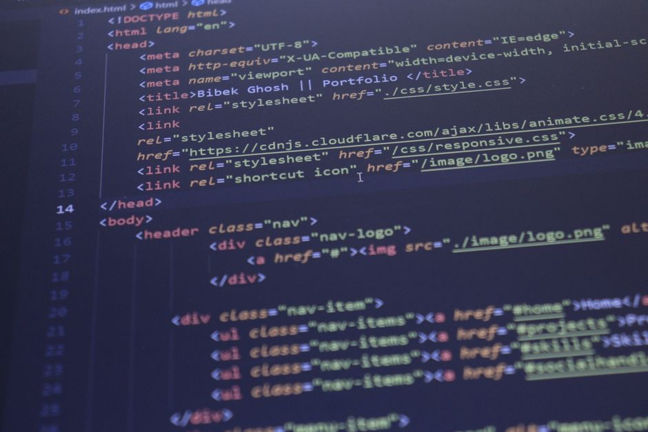 computer monitor displaying lines of html code for a small business web design header in angleton. market design team: define. structure. expand.
